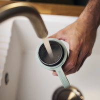 Filling water in green BRITA water filter bottle Model Active