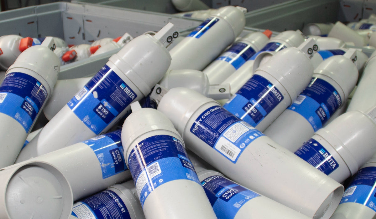 Collection of BRITA professional filter cartridges with blue labels.