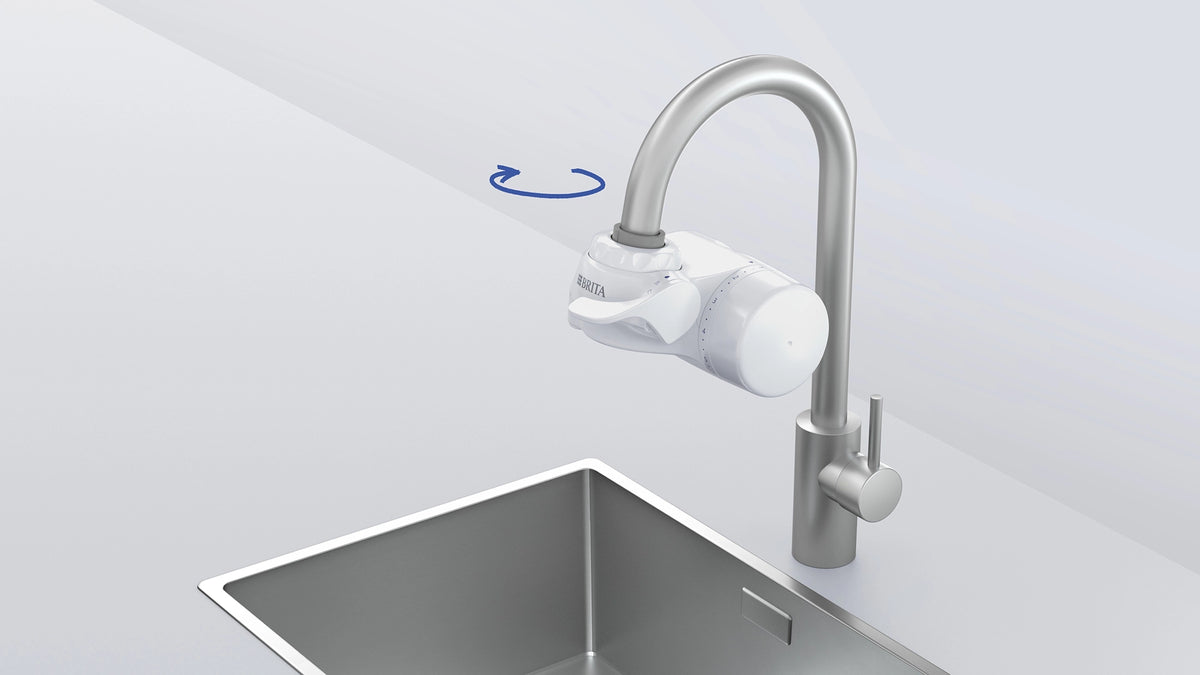 Installation illustration showing the BRITA ON TAP filter being rotated into position on a kitchen faucet